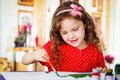 Happy little artistic girl painting Royalty Free Stock Photo