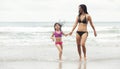 Happy little asia girl with her mother running on the beach Royalty Free Stock Photo