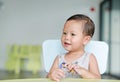 Happy little Asian baby boy eating chocolate in the classroom Royalty Free Stock Photo