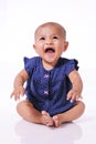 Happy little asian baby girl laughing sitting on white floor Royalty Free Stock Photo