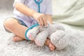 Happy little asian boy playing pretend to be a doctor.asian kid examine him teddy bear with stethoscope.ambition and child Royalty Free Stock Photo