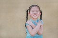 Happy little Asian child girl expression cross one`s arm and closed eyes. Confident and cheerful kids