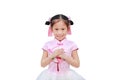 Happy little Asian child girl wearing pink traditional Chinese dress with greeting gesture celebration for Chinese New Year Royalty Free Stock Photo