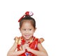 Happy little Asian child girl wearing red cheongsam with greeting gesture celebration for Chinese New Year isolated on white Royalty Free Stock Photo