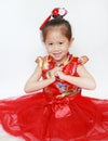 Happy little Asian child girl wearing red cheongsam with greeting gesture celebration for Chinese New Year isolated on white Royalty Free Stock Photo