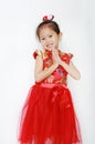Happy little Asian child girl wearing red cheongsam with greeting gesture celebration for Chinese New Year isolated on white Royalty Free Stock Photo