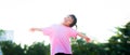 Happy little Asian cute girl spread both arms and tilted neck. Sweet smile child holding hands up. Looks at camera. Royalty Free Stock Photo