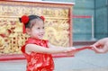 Happy little Asian girl received a red envelope. Chinese New Year celebration Royalty Free Stock Photo