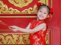 Happy little Asian girl received a red envelope. Chinese New Year celebration Royalty Free Stock Photo