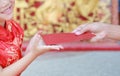 Happy little Asian girl received a red envelope. Chinese New Year celebration Royalty Free Stock Photo