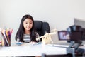 Happy little Asian girl sitting at the white table and live streaming for social media with happiness by camera select focus