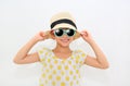 Happy little asian girl wearing a sunglasses and straw hat isolated on white background. Summer and fashion concept. Front view Royalty Free Stock Photo