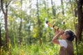 Happy Little Asian girls looking ahead and smiling child with the binoculars in the park. Travel and adventure concept. Freedom, Royalty Free Stock Photo