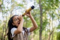 Happy Little Asian girls looking ahead and smiling child with the binoculars in the park. Travel and adventure concept. Freedom, Royalty Free Stock Photo