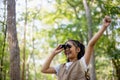 Happy Little Asian girls looking ahead and smiling child with the binoculars in the park. Travel and adventure concept. Freedom, Royalty Free Stock Photo