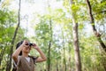 Happy Little Asian girls looking ahead and smiling child with the binoculars in the park. Travel and adventure concept. Freedom, Royalty Free Stock Photo