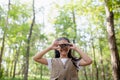 Happy Little Asian girls looking ahead and smiling child with the binoculars in the park. Travel and adventure concept. Freedom, Royalty Free Stock Photo