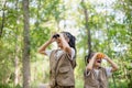 Happy Little Asian girls looking ahead and smiling child with the binoculars in the park. Travel and adventure concept. Freedom, Royalty Free Stock Photo