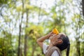 Happy Little Asian girls looking ahead and smiling child with the binoculars in the park. Travel and adventure concept. Freedom, Royalty Free Stock Photo