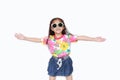 Happy little Asian kid girl stretch arms wide open wearing a floral pattern summer dress and sunglasses isolated on white Royalty Free Stock Photo