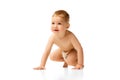 Happy little baby boy in diaper child sitting, smiling, playing isolated over white studio background Royalty Free Stock Photo