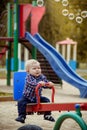 Happy little baby boy playing on the playground in the summer or autumn Royalty Free Stock Photo