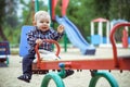 Happy little baby boy playing on the playground in the summer or autumn Royalty Free Stock Photo