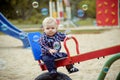 Happy little baby boy playing on the playground in the summer Royalty Free Stock Photo