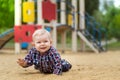 Happy little baby boy playing on the playground in the summer Royalty Free Stock Photo