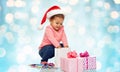 Happy little baby girl with christmas presents