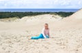 Happy little baby girl enjoys sand playing in the dunes Royalty Free Stock Photo