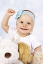 Happy little baby girl among plush toys Royalty Free Stock Photo