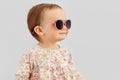 Happy little baby girl in sunglasses over grey Royalty Free Stock Photo