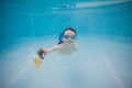 Happy little baby swims underwater in the pool with action camera . Shooting under water. Landscape orientation