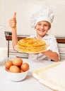 Happy little baker with tasty pancakes