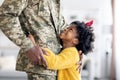 Happy Little Black Daughter Hugging Soldier Father In Military Uniform At Home Royalty Free Stock Photo