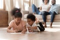 Happy little black kids lying on floor painting Royalty Free Stock Photo