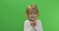 Happy little blonde girl in white t-shirt. Cute blonde child. Making faces Royalty Free Stock Photo