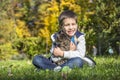 Happy little boy in the autumn park with pet kitten. Royalty Free Stock Photo