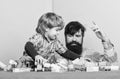 Happy little boy with bearded man dad playing together. father and son play game. building home with colorful Royalty Free Stock Photo