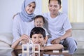 Happy little boy builds a house with his family Royalty Free Stock Photo