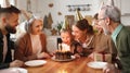 Happy little boy celebrating birthday with family at home, looking at cake with lit candles Royalty Free Stock Photo