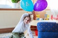 Happy little boy celebrating his 4 birthday with colorful balloons