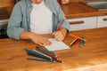 Happy Little Boy Does Homework, Writes Down Useful Information. Distance Learning, e-Education, e-