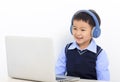 Happy little boy doing homework and learning on the laptop Royalty Free Stock Photo