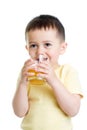 Happy little boy drinking fresh juice, isolated on white background Royalty Free Stock Photo