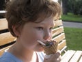 Happy little boy eating an ice cream outdoors Royalty Free Stock Photo