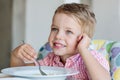 Happy little boy eating soup Royalty Free Stock Photo