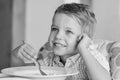 Happy little boy eating soup Royalty Free Stock Photo