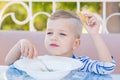 Happy little boy eating soup in the cafe Royalty Free Stock Photo